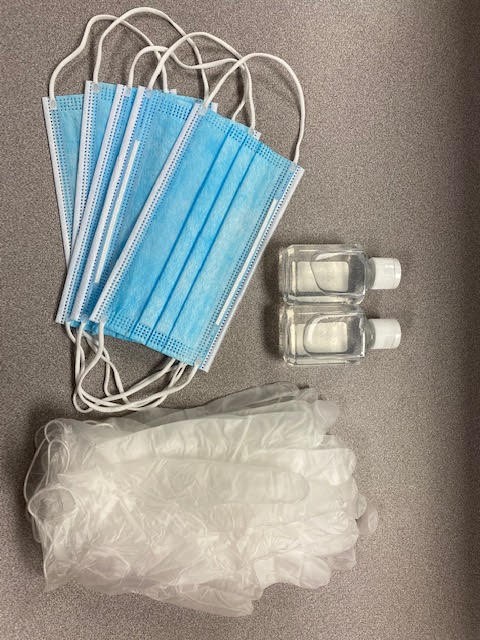Five face masks, 2 small bottles of hand sanitizer, and five pairs of gloves