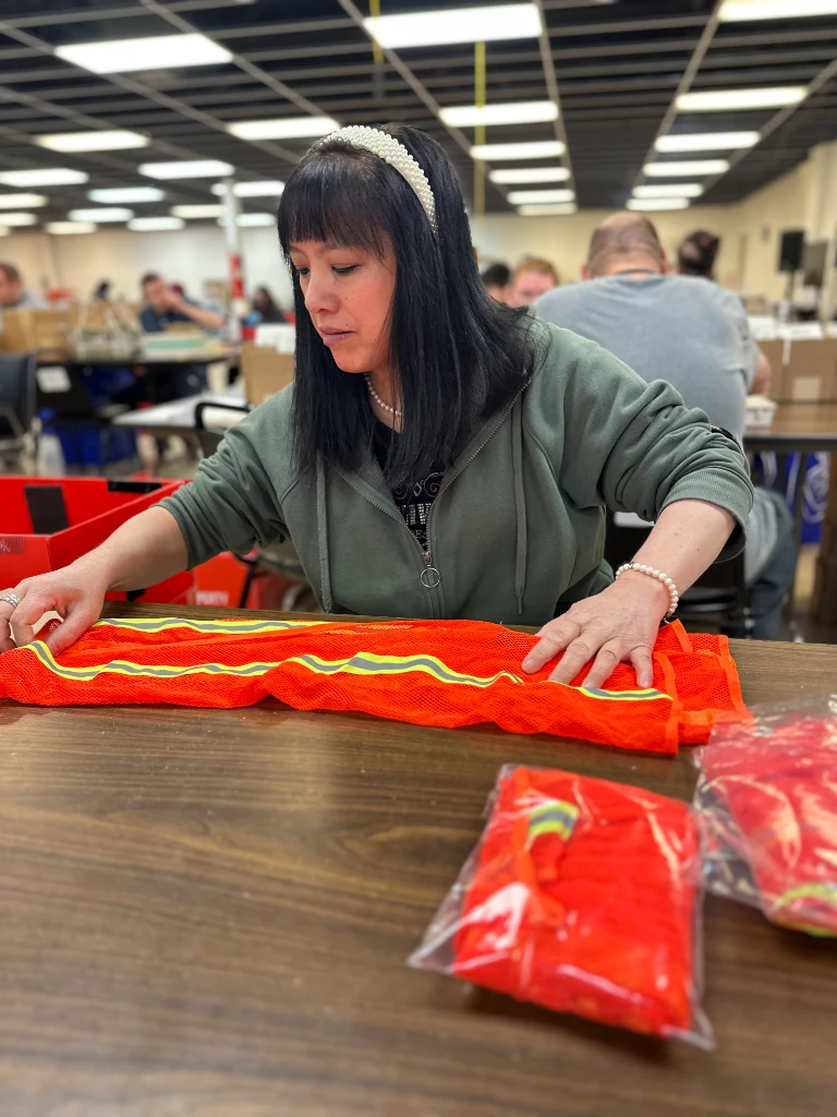 Worker folding safety vests, Kitting and assembly NJ